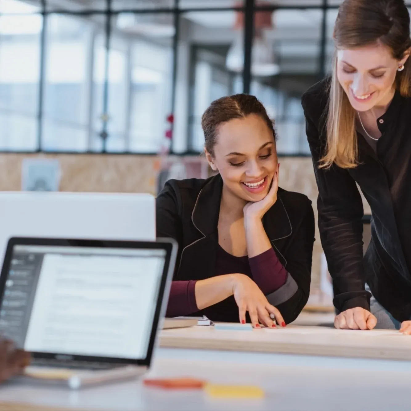 Retail manager discussing product details with staff in a supermarket aisle representing key business industries.