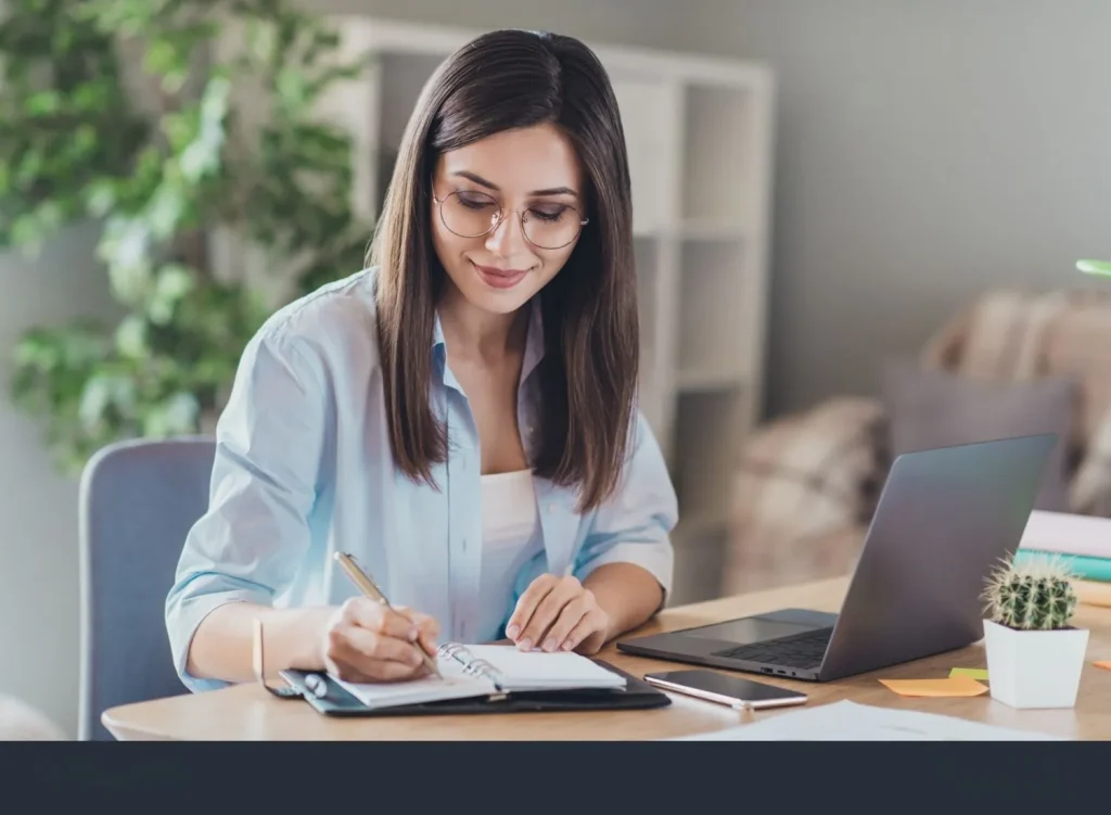 Businesswoman in Connecticut managing sales and accounting using a modern POS system and laptop.